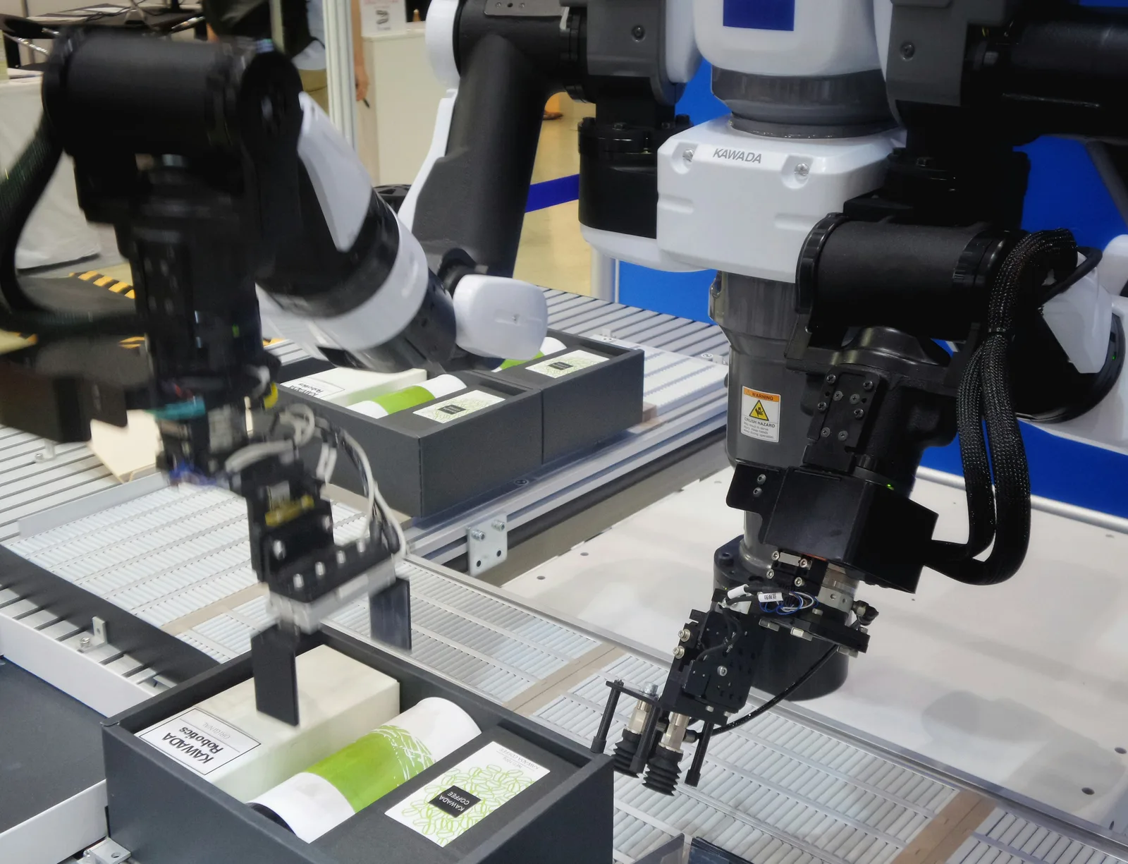 Industrial robotic arms handling packages on a production line