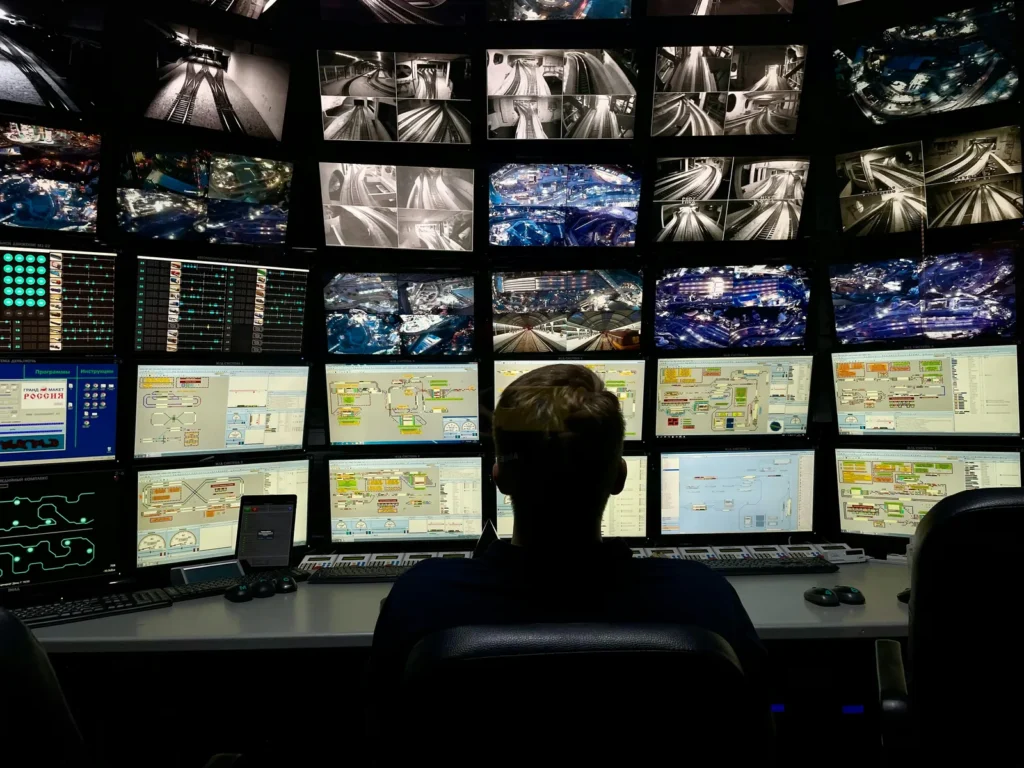 Operator watching multiple security monitors