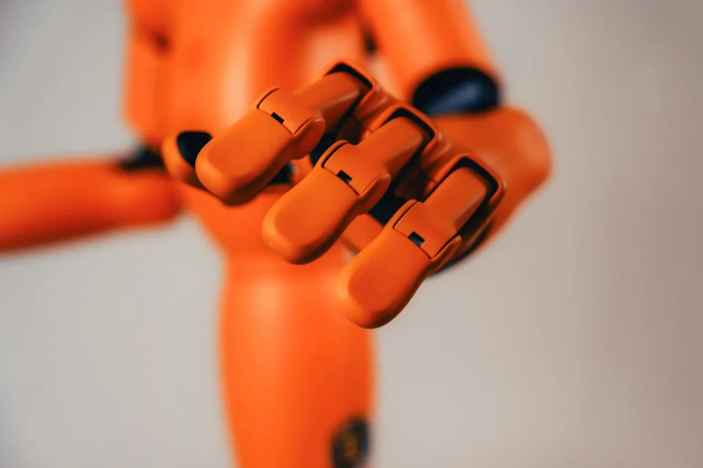 Orange robot hand with curled fingers