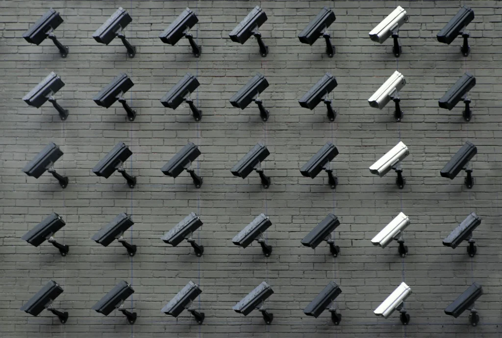 Repeating rows of wall-mounted security cameras