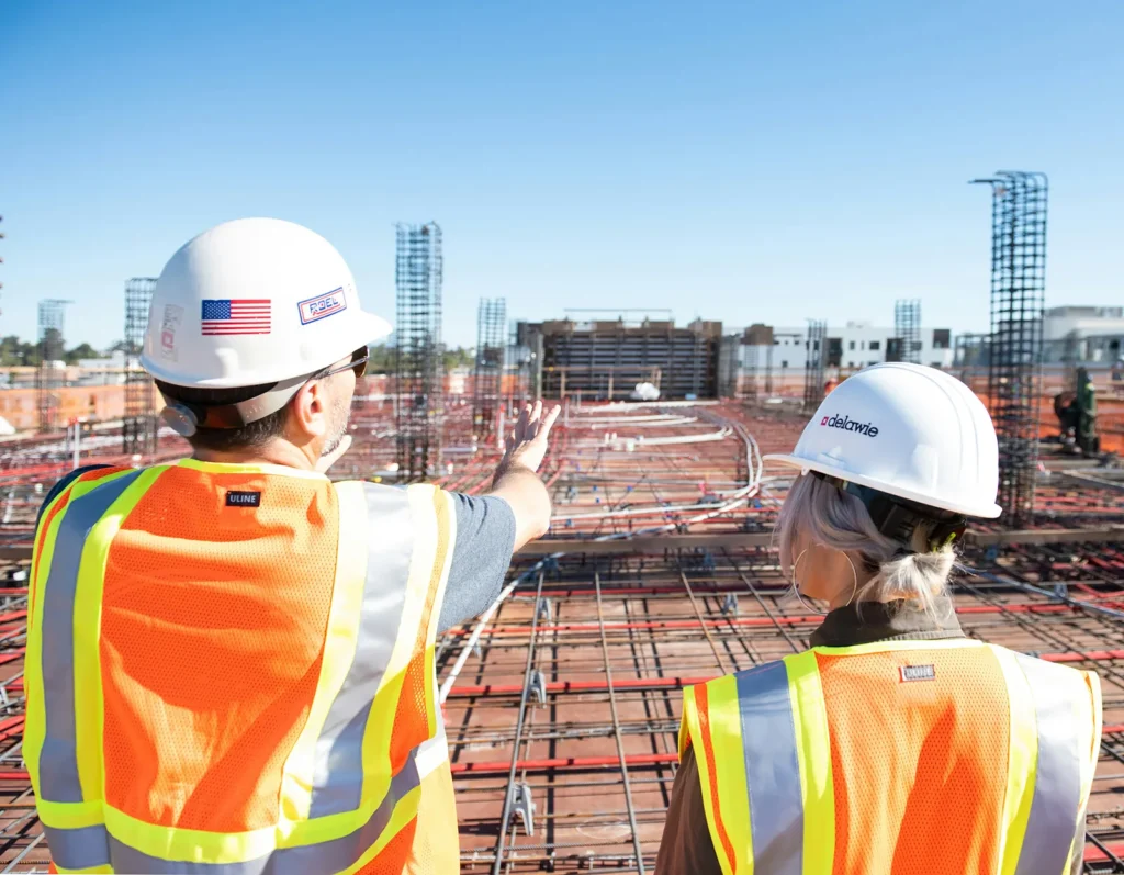 Two workers overlooking a construction site