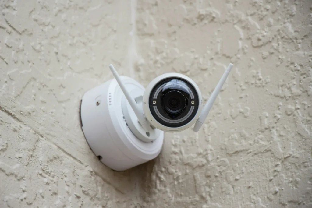 White security camera on a textured wall